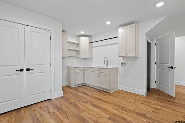 a view of empty room with wooden floor and ceiling fan