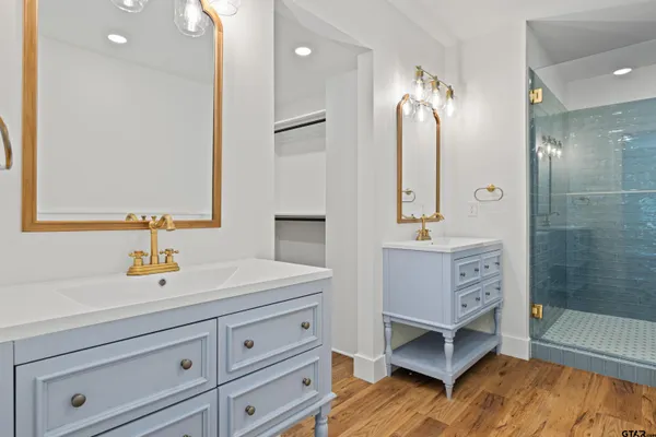 a bathroom with a sink a mirror and a shower