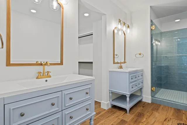 a bathroom with a sink a mirror and a shower