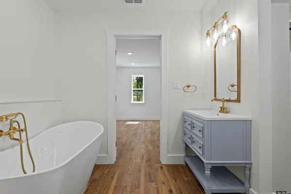 a bathroom with a sink toilet a mirror and vanity