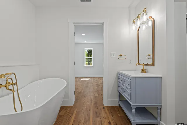 a bathroom with a sink toilet a mirror and vanity