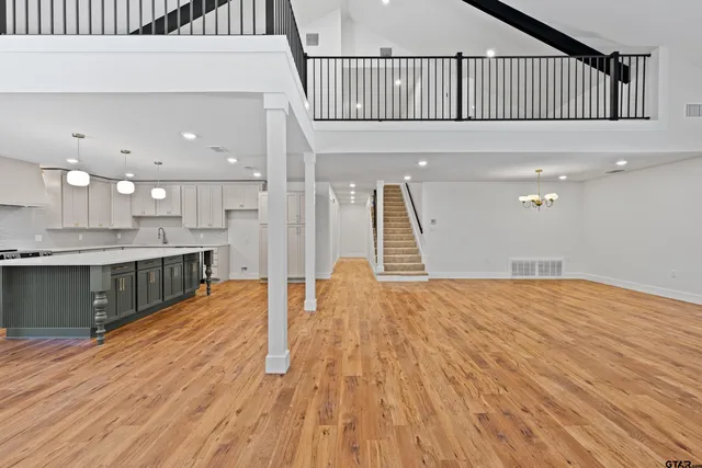 a view of a kitchen with wooden floor and a window