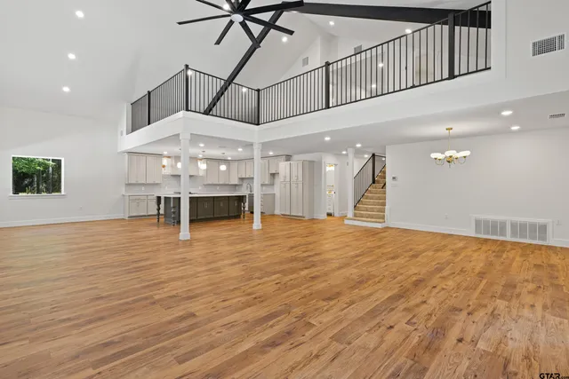 a view of an empty room with a window and stairs