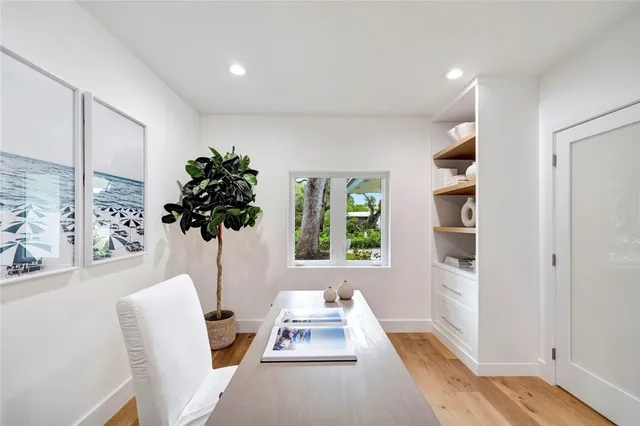 a white room with furniture and a potted plant