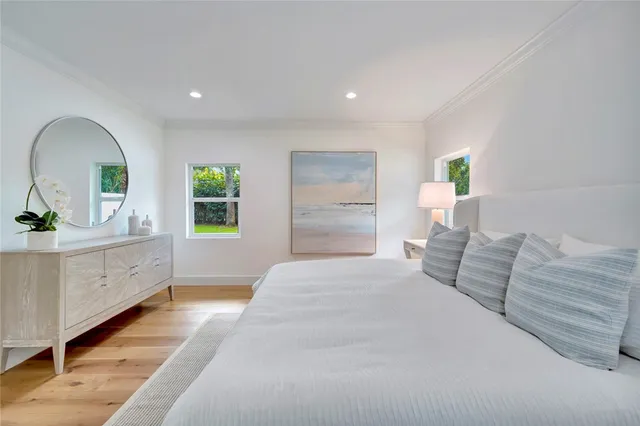 a spacious bedroom with a large bed and a dresser