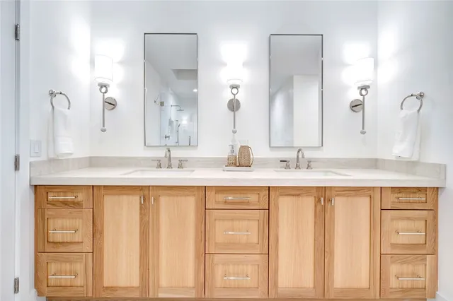 a bathroom with a double vanity sink and a mirror