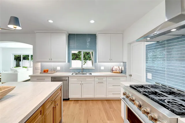 a kitchen with a stove a sink and a refrigerator
