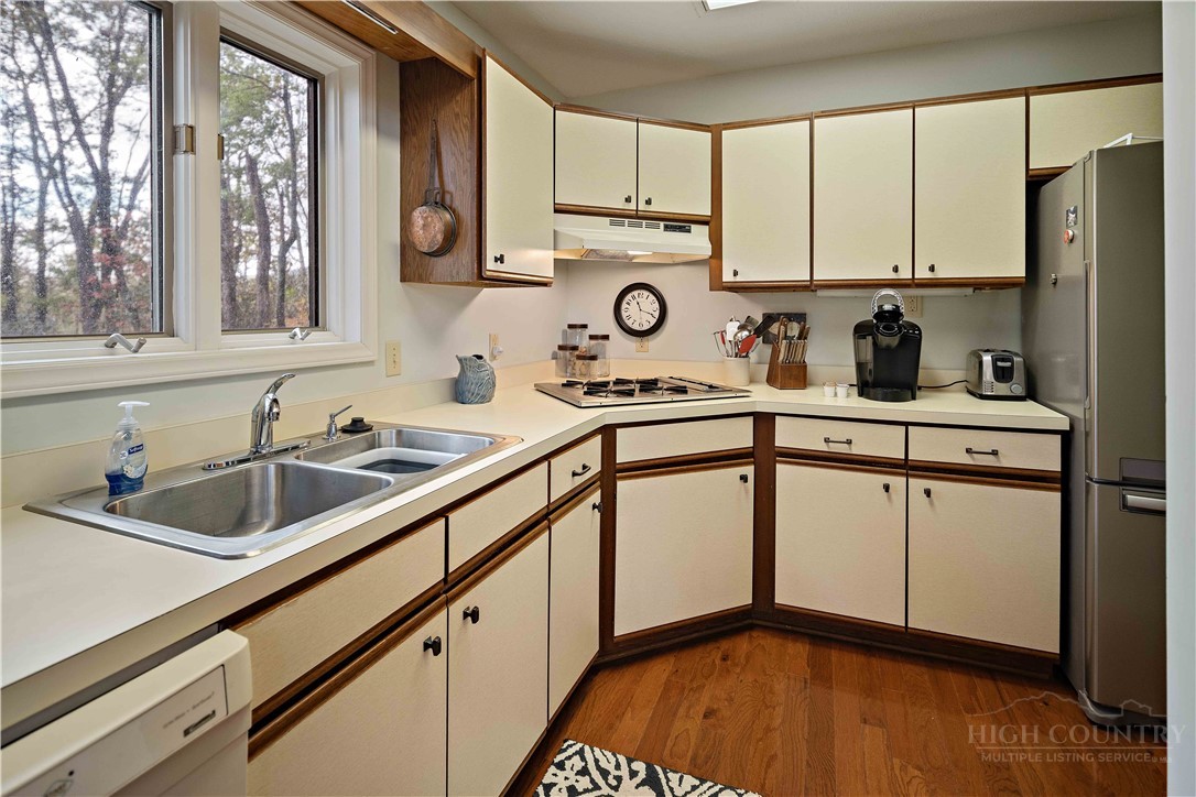 265 Leatherwood Road Banner Elk, NC 28604 - Photo 20 of 42 a kitchen with stainless steel appliances a sink stove and cabinets