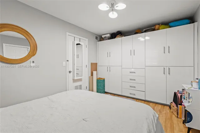 a bedroom with a bed and a book shelf