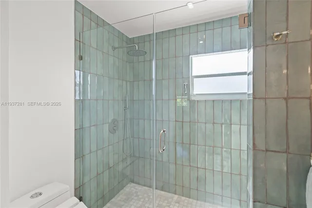 a bathroom with a double vanity sink mirror and shower