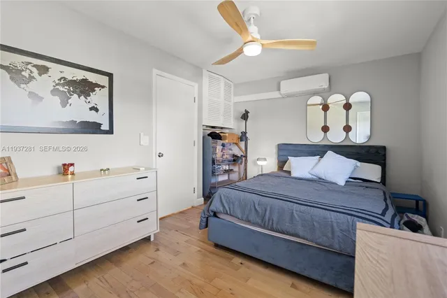 a bedroom that has a bed and a chandelier in it