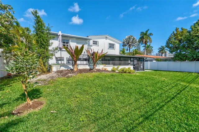 a view of a house with a yard and sitting area
