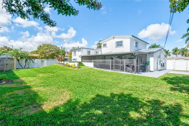 a view of a house with a backyard porch and sitting area