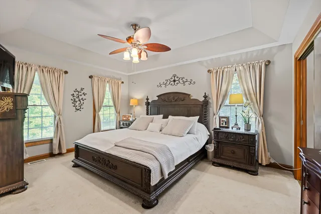 a bedroom with a bed and a flat tv screen on dresser