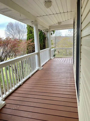 an aerial view of a house with a yard and lake view