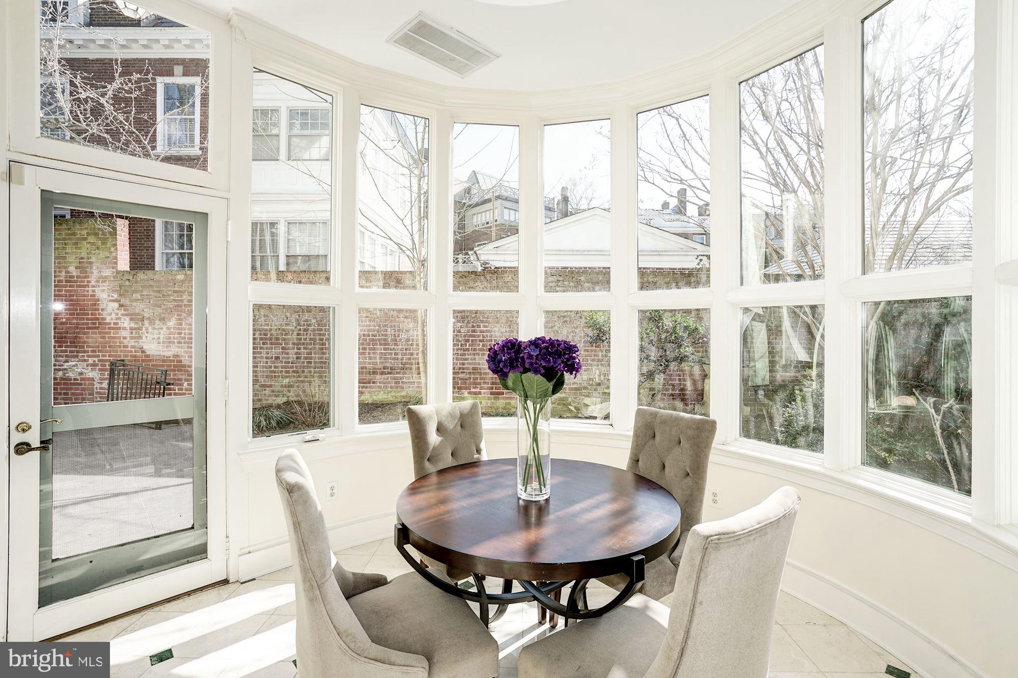 84 Kalorama Circle Northwest Washington, DC 20008 - Photo 13 of 45 a dining room with furniture and a floor to ceiling window