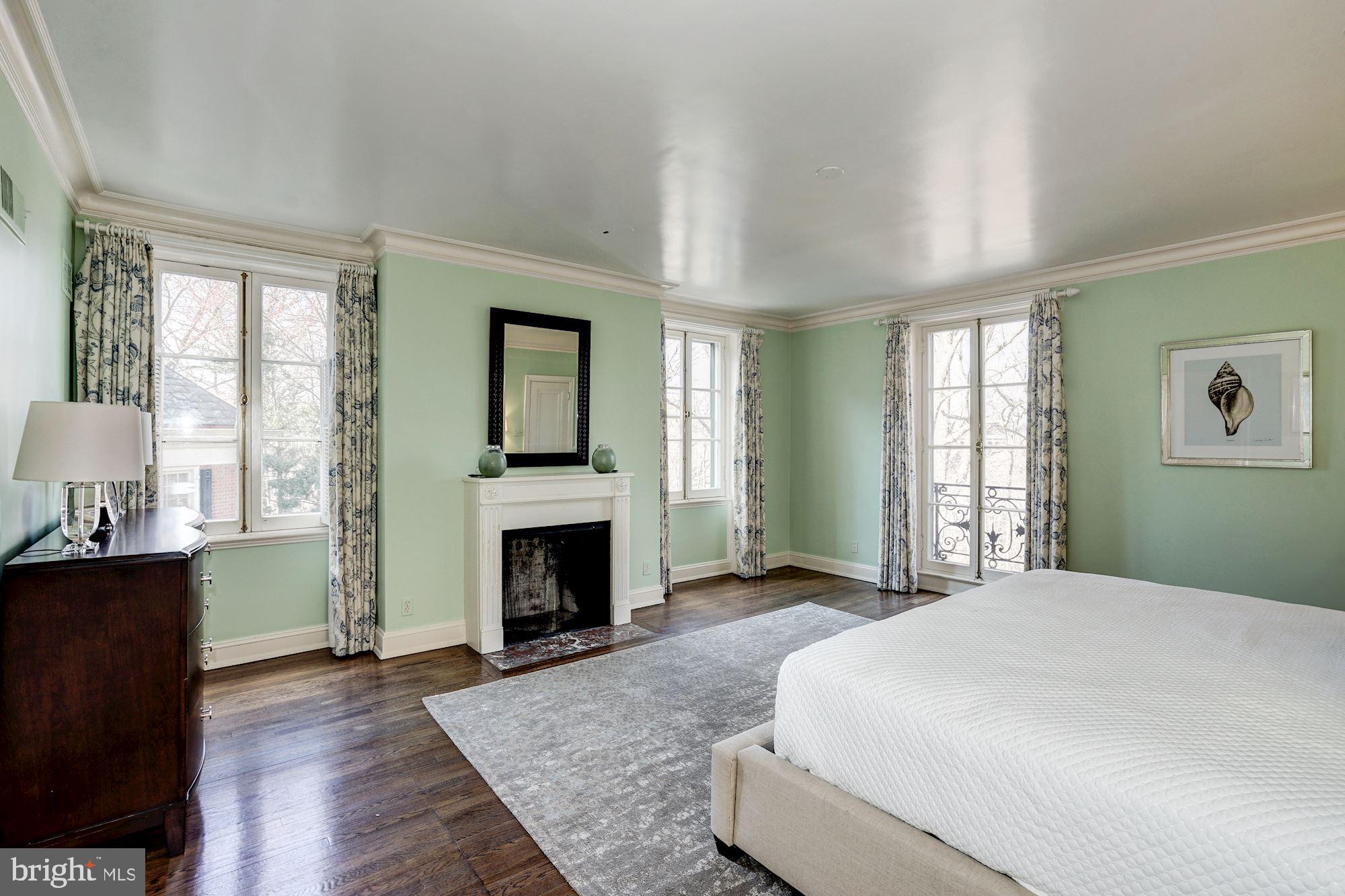 84 Kalorama Circle Northwest Washington, DC 20008 - Photo 25 of 45 a spacious bedroom with a bed and a fireplace