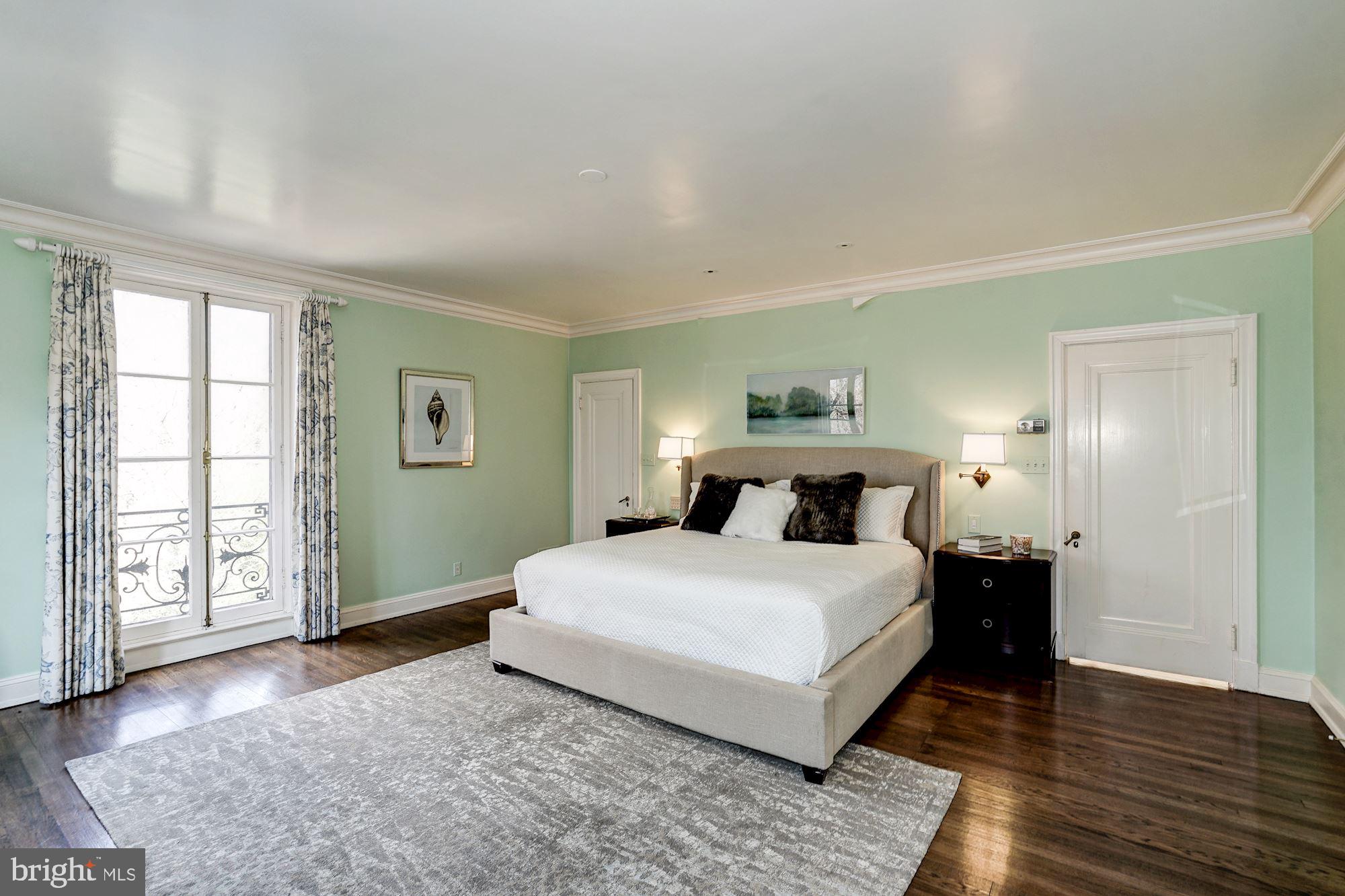 84 Kalorama Circle Northwest Washington, DC 20008 - Photo 26 of 45 a bedroom with a large bed and wooden floor