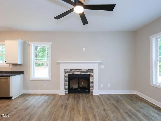 wooden floor fireplace and windows in a room
