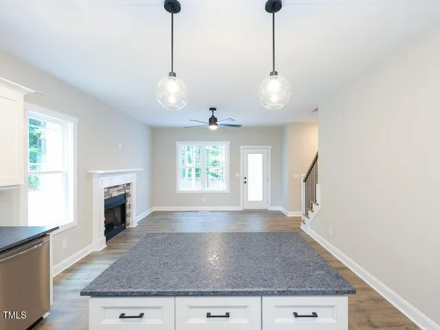 a view of empty room with window and fireplace