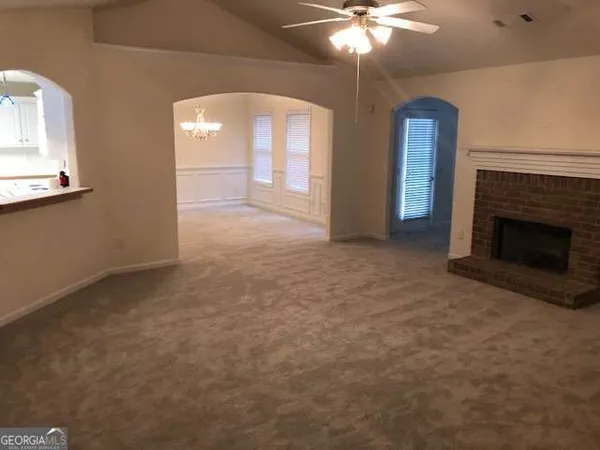 a view of an empty room with a fireplace
