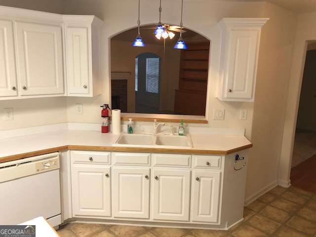 225 Lexington Circle Athens, GA 30605 - Photo 14 of 23 a kitchen with white cabinets and chandelier