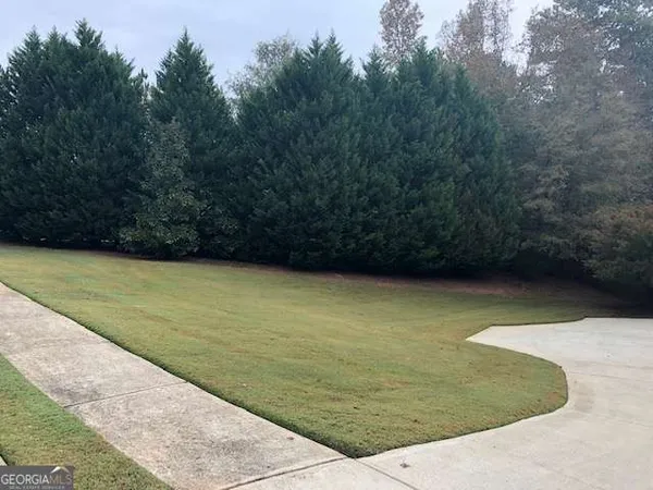 a view of a swimming pool with a yard