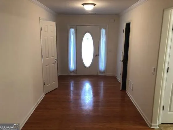 a view of a hallway with wooden floor