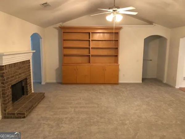 a view of a livingroom with an empty space and a fireplace