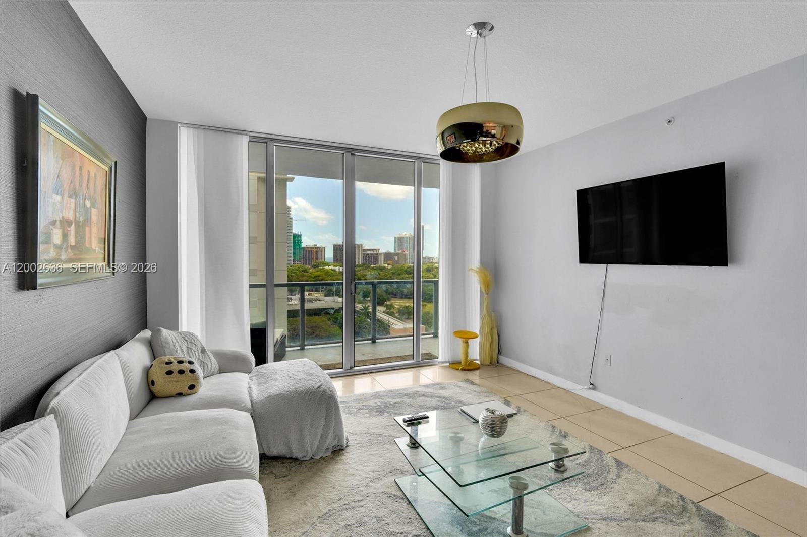 a living room with furniture a flat screen tv and a large window