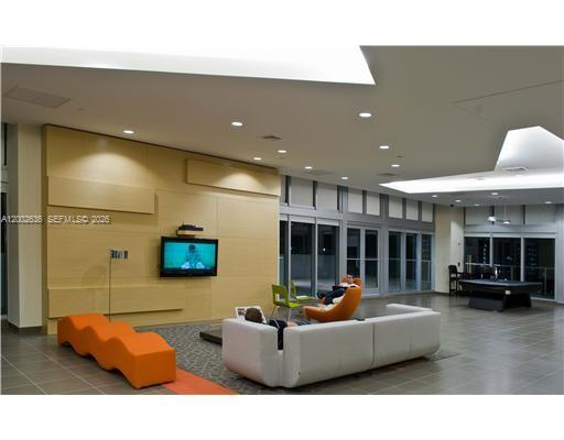 79 Southwest 12th Street, Unit 1605 Miami, FL 33130 - Photo 28 of 30 a living room with furniture and a flat screen tv