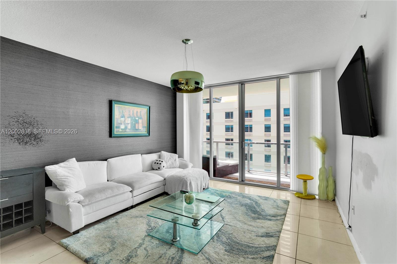 79 Southwest 12th Street, Unit 1605 Miami, FL 33130 - Photo 4 of 30 a living room with furniture a rug and a flat screen tv