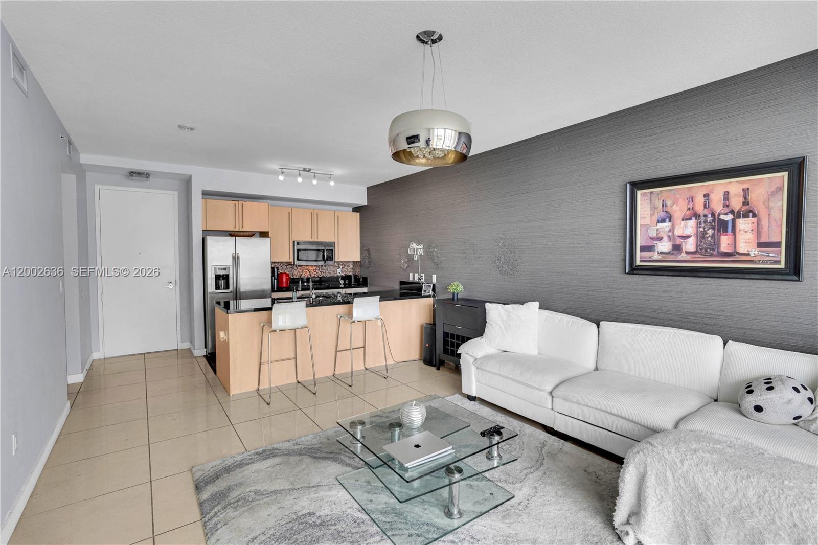 79 Southwest 12th Street, Unit 1605 Miami, FL 33130 - Photo 5 of 30 a living room with furniture a rug and kitchen view