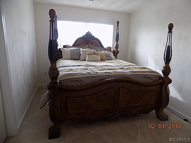 9324 Alcove Grove Road Chesterfield, VA 23832 - Photo 16 of 29 a bedroom with a bed and a mirror