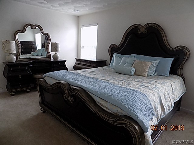 9324 Alcove Grove Road Chesterfield, VA 23832 - Photo 17 of 29 a bedroom with a bed and a dresser