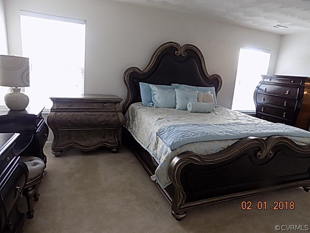9324 Alcove Grove Road Chesterfield, VA 23832 - Photo 18 of 29 a bedroom with a bed and a dresser
