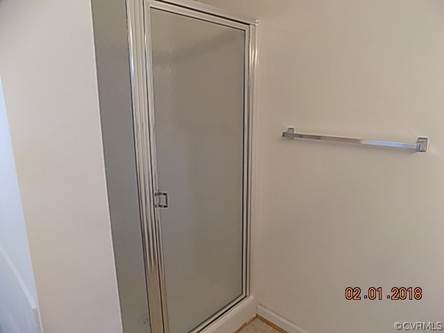 9324 Alcove Grove Road Chesterfield, VA 23832 - Photo 22 of 29 a bathroom with a glass shower door
