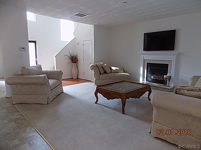 9324 Alcove Grove Road Chesterfield, VA 23832 - Photo 3 of 29 a living room with furniture a flat screen tv and a fireplace