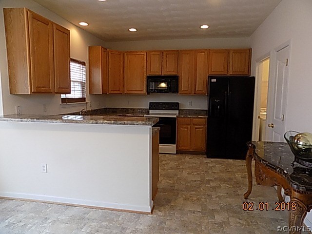9324 Alcove Grove Road Chesterfield, VA 23832 - Photo 8 of 29 a kitchen with granite countertop wooden cabinets and stainless steel appliances
