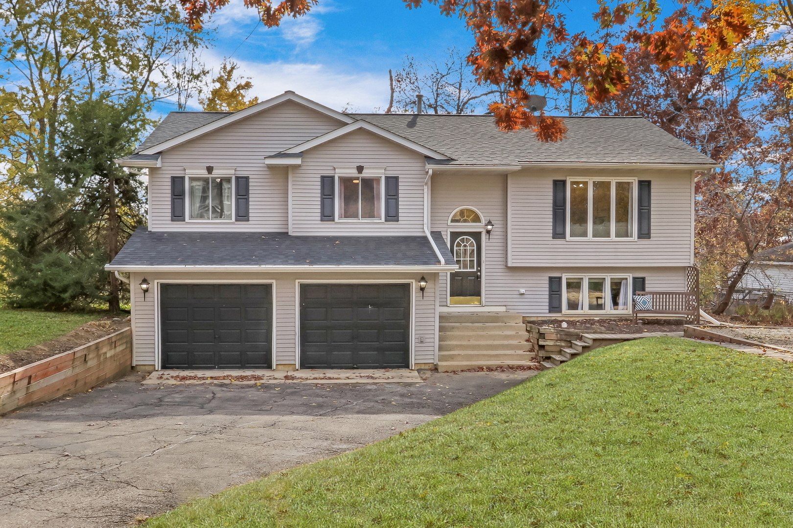 a front view of a house with a yard and garage