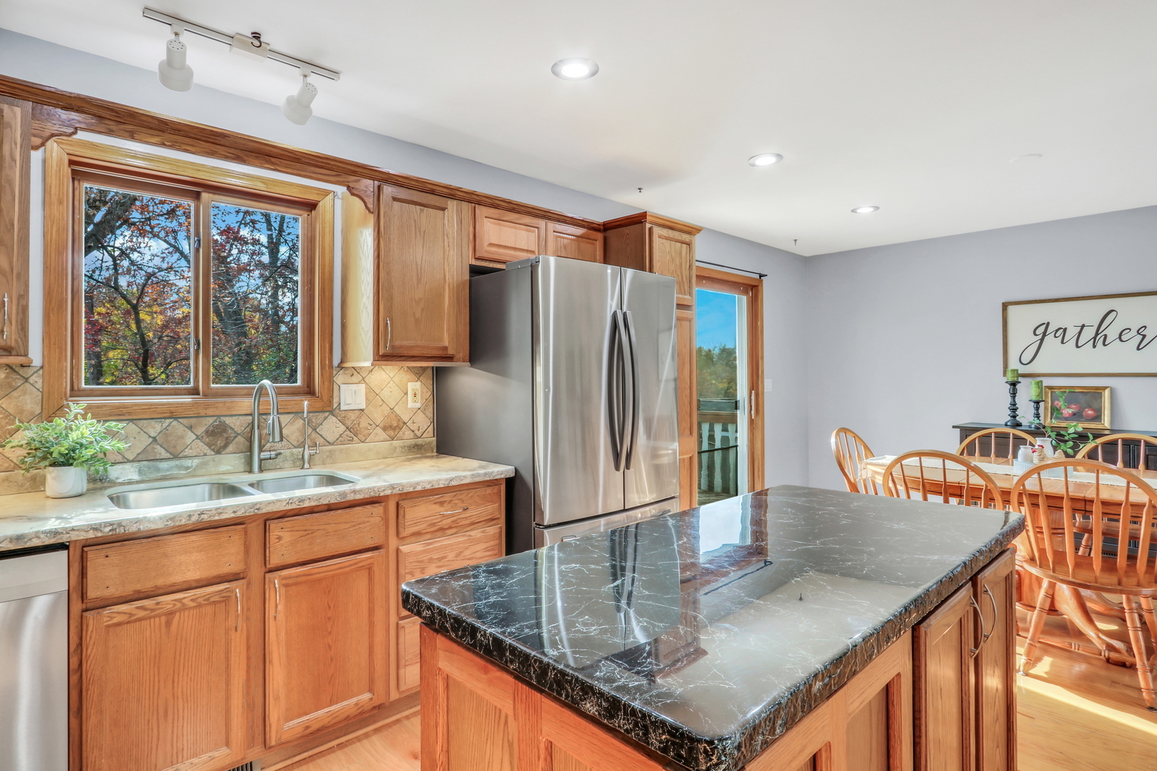25911 West Highpoint Road Ingleside, IL 60041 - Photo 11 of 29 a kitchen with stainless steel appliances granite countertop a sink a stove and a refrigerator