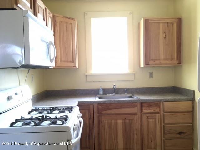 433 East 2nd Street Rifle, CO 81650 - Photo 4 of 8 a kitchen with stainless steel appliances granite countertop a sink stove and cabinets