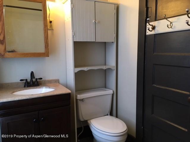 433 East 2nd Street Rifle, CO 81650 - Photo 6 of 8 a bathroom with a granite countertop toilet sink and mirror