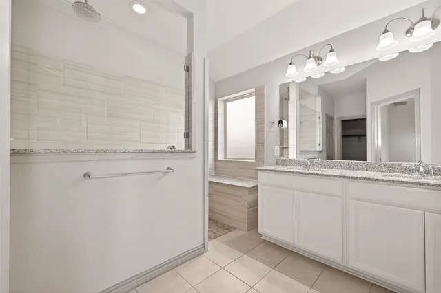 an empty room with chandelier fan and windows