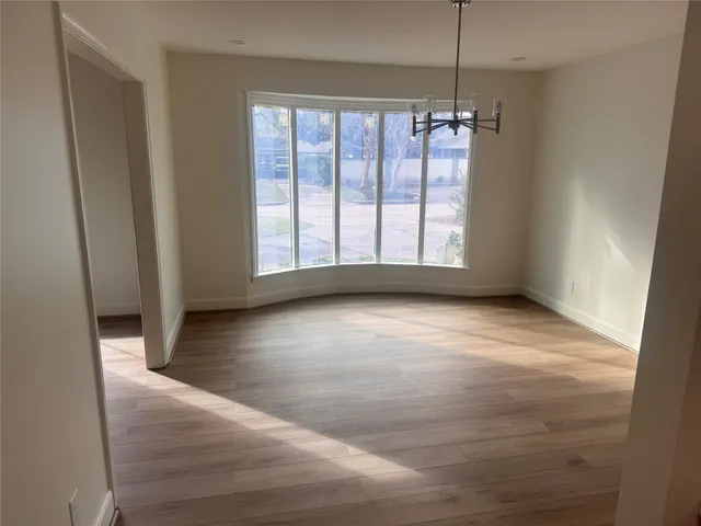 a kitchen with stainless steel appliances granite countertop a refrigerator a sink and a stove