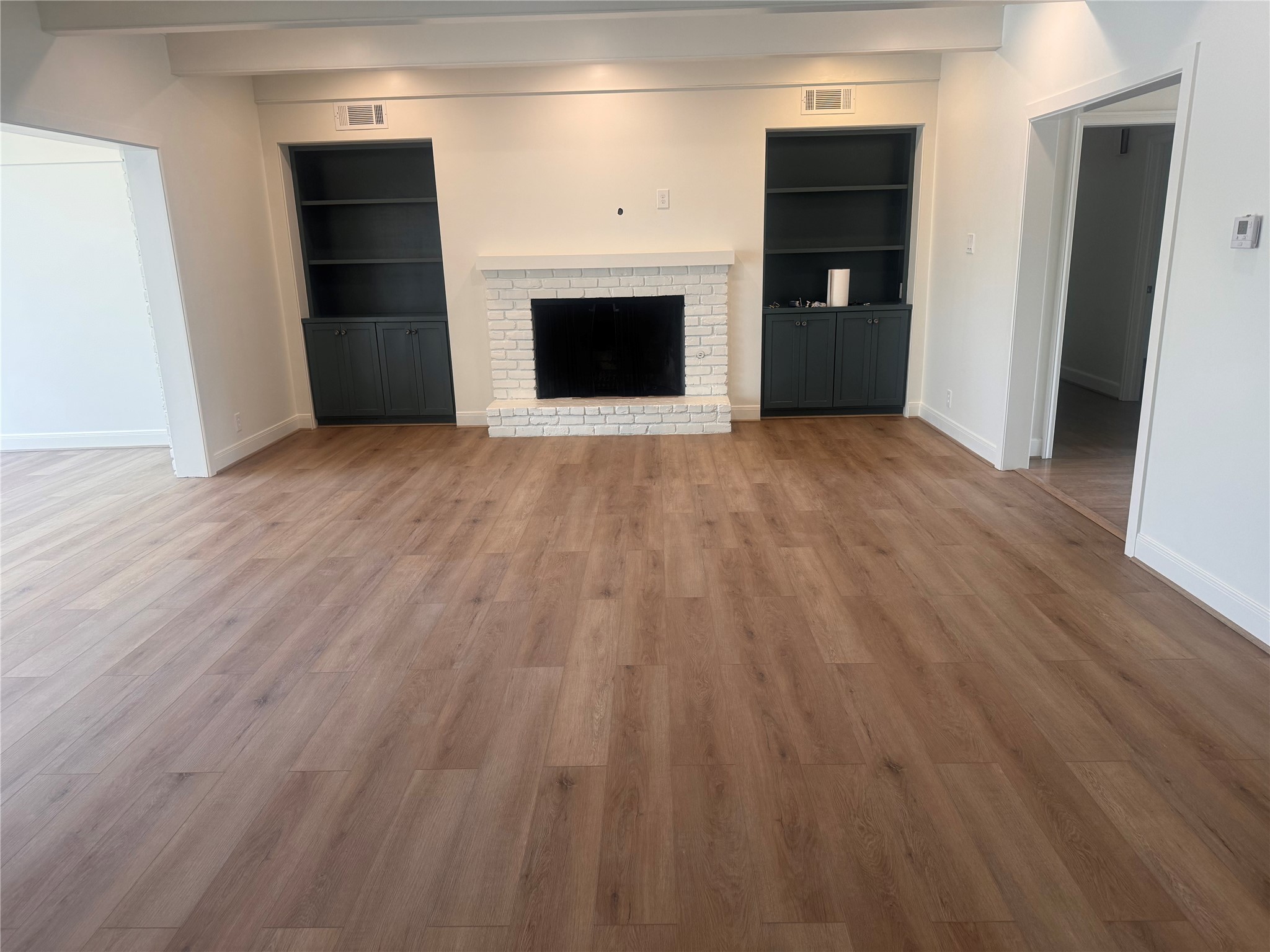 4726 Ivanhoe Street Houston, TX 77027 - Photo 5 of 22 Family room with wood burning fireplace and built ins. Through the cased opening on the left is a Sunroom with views of the pool.