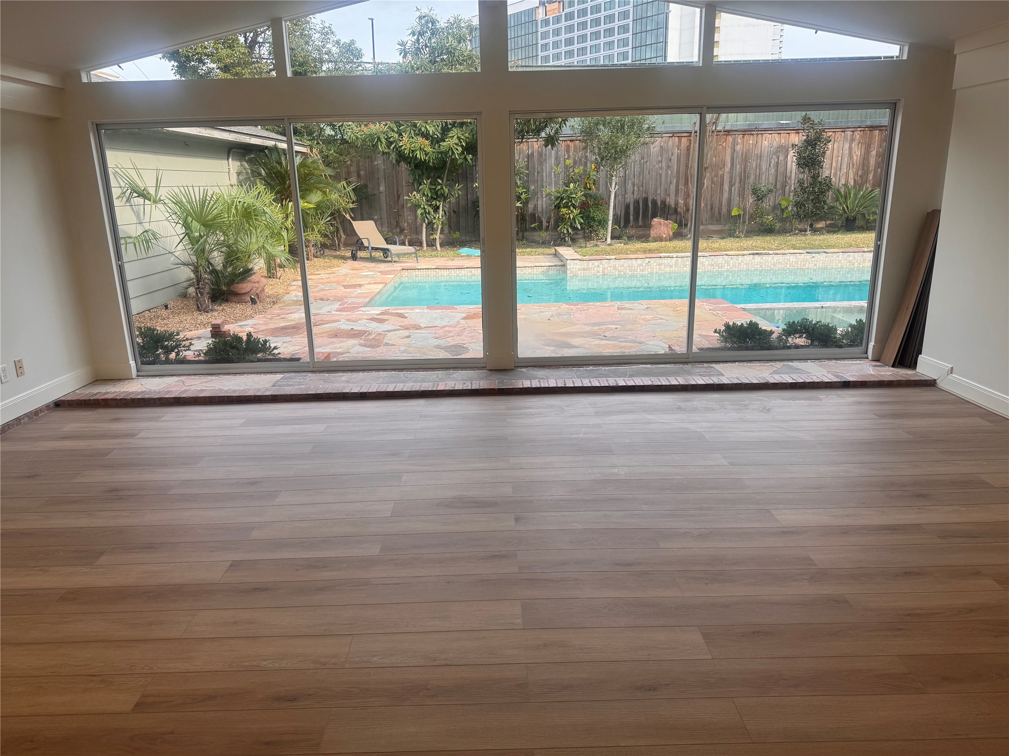 4726 Ivanhoe Street Houston, TX 77027 - Photo 6 of 22 Sunroom off of the family room overlooking the backyard and swimming pool.