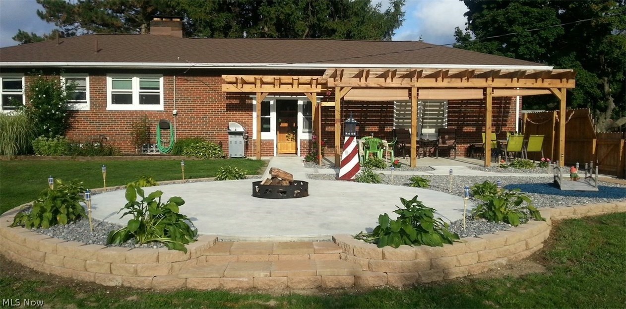 4378 Lane Road Painesville, OH 44077 - Photo 2 of 31 View of backyard, concrete patio, and Pergola. Great outdoor entertaining space.
