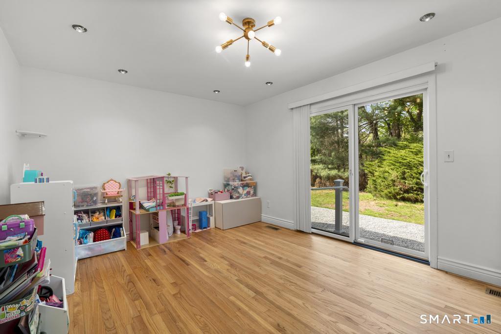 45 Ansonia Road Woodbridge, CT 06525 - Photo 12 of 23 family room with sliding glass doors