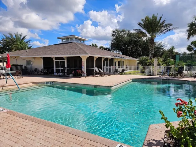 a view of a house with a yard patio and swimming pool